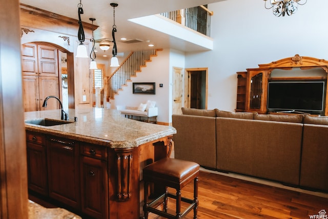 493 N 12500 W, Bluebell, UT 84007 - kitchen with sink, dark hardwood / wood-style flooring, an island with sink, pendant lighting, and light stone countertops
