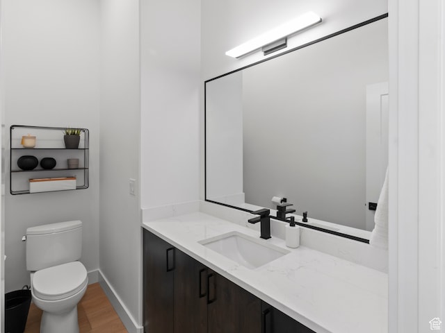 2971 S Sand Trap Cir Unit 64, Garden City, UT 84028 - bathroom featuring vanity, toilet, and hardwood / wood-style flooring