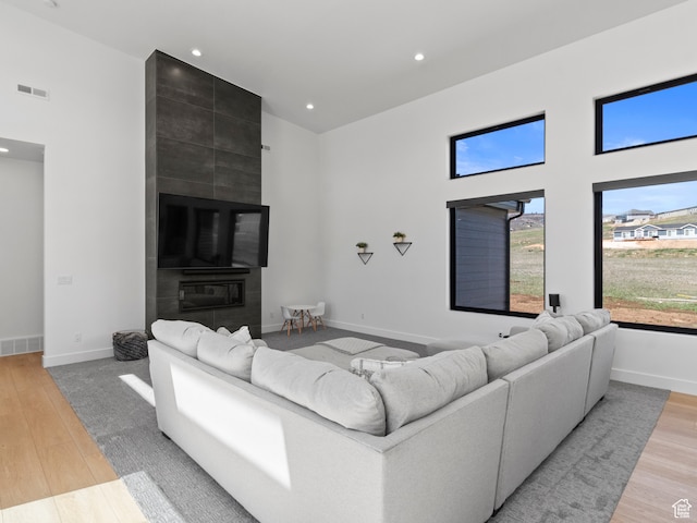 2971 S Sand Trap Cir Unit 64, Garden City, UT 84028 - living room with a tile fireplace and light wood-type flooring