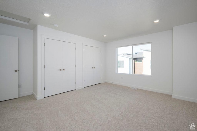 4119 S Winder Ward Dr E Unit 3-106, Millcreek, UT 84124 - unfurnished bedroom with multiple closets, light carpet, baseboards, and recessed lighting