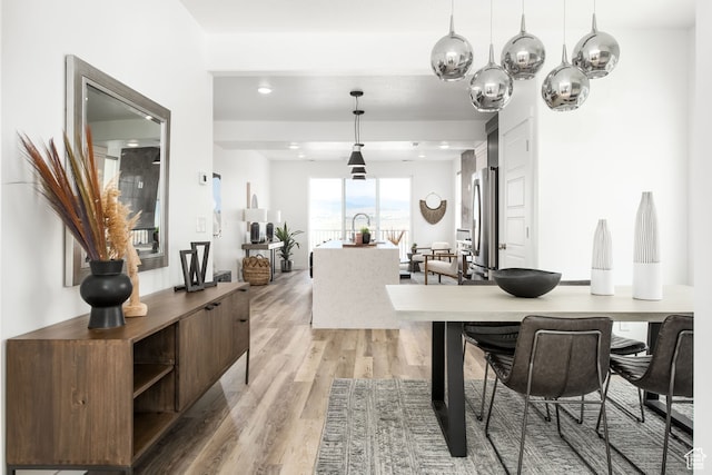 dining room featuring light wood finished floors, a chandelier, and recessed lighting