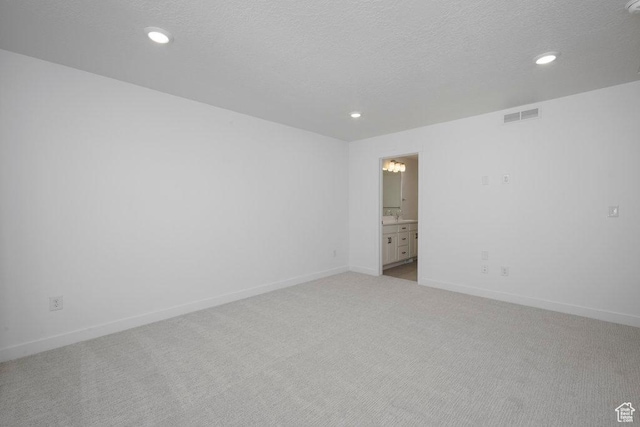 4119 S Winder Ward Dr E Unit 3-106, Millcreek, UT 84124 - unfurnished room with light colored carpet, recessed lighting, baseboards, and a textured ceiling