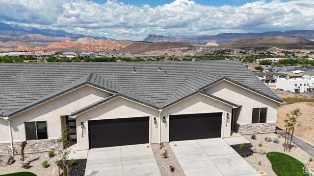 2086 W 320 S, Hurricane, UT 84737 - ranch-style home with a mountain view, an attached garage, driveway, and stucco siding