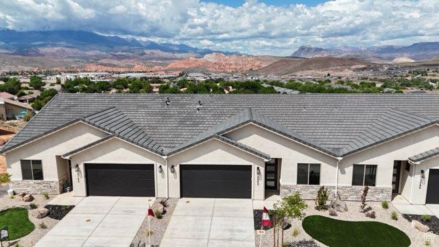 2086 W 320 S, Hurricane, UT 84737 - ranch-style home featuring a mountain view, stucco siding, concrete driveway, and stone siding
