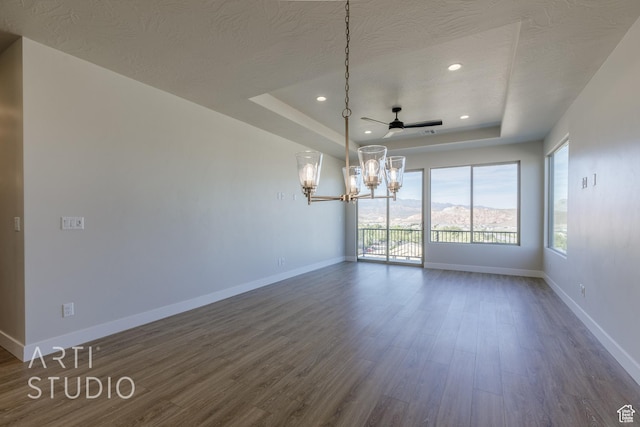 2086 W 320 S, Hurricane, UT 84737 - spare room with a tray ceiling, a chandelier, dark wood finished floors, baseboards, and ceiling fan