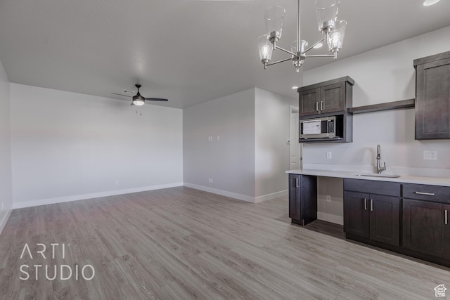 2086 W 320 S, Hurricane, UT 84737 - kitchen featuring a sink, light wood finished floors, stainless steel microwave, light countertops, and ceiling fan