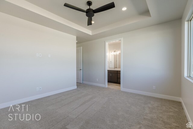 2086 W 320 S, Hurricane, UT 84737 - unfurnished bedroom with light carpet, a tray ceiling, baseboards, recessed lighting, and connected bathroom