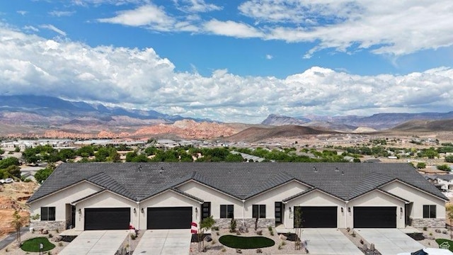 2086 W 320 S, Hurricane, UT 84737 - ranch-style house with a mountain view, driveway, an attached garage, and stucco siding