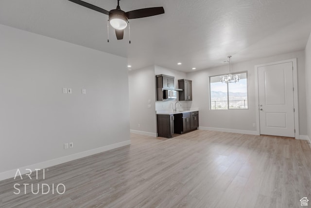 2086 W 320 S, Hurricane, UT 84737 - unfurnished living room with a chandelier, light wood-style flooring, a ceiling fan, baseboards, and recessed lighting