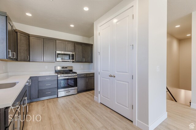 2086 W 320 S, Hurricane, UT 84737 - kitchen featuring stainless steel appliances, light wood-type flooring, dark brown cabinetry, light countertops, and recessed lighting