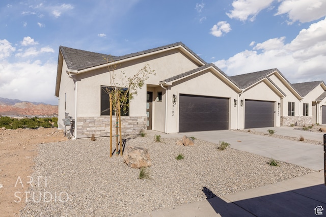 view of front facade with a mountain view and a garage