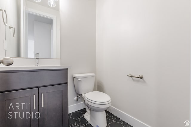 bathroom featuring vanity, toilet, and tile patterned floors