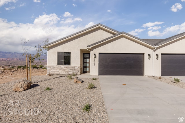 view of front of property with a mountain view and a garage