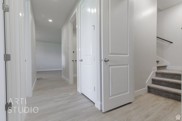 hallway with light hardwood / wood-style floors