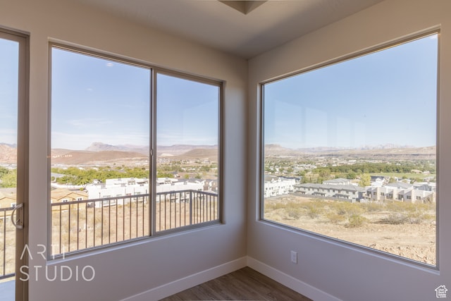 unfurnished sunroom with a mountain view