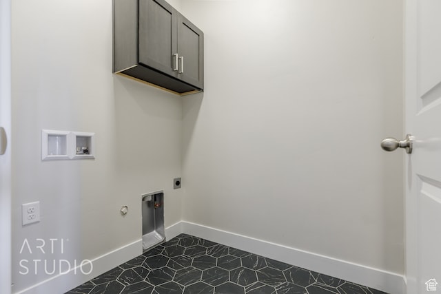 laundry area featuring cabinets, washer hookup, dark tile patterned floors, electric dryer hookup, and hookup for a gas dryer