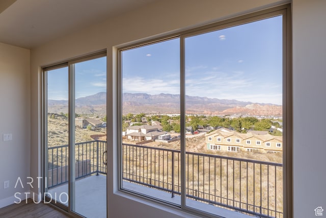 doorway to outside with a mountain view and hardwood / wood-style floors