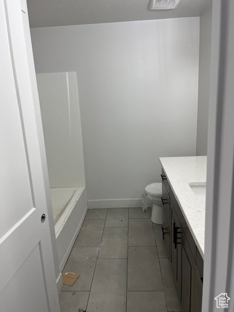 bathroom featuring vanity, tile patterned flooring, and toilet