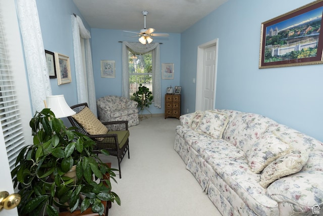 living area with ceiling fan and carpet floors