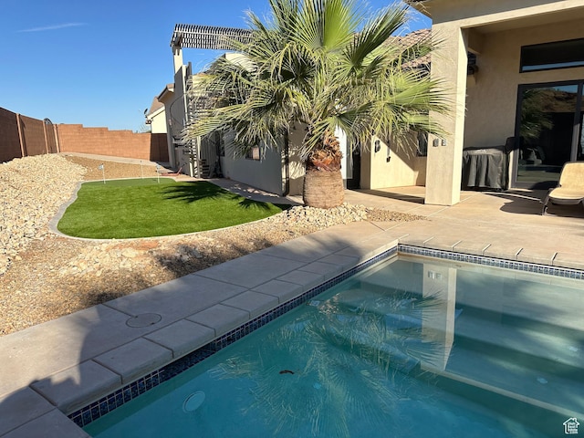 view of swimming pool with a patio area and fence private yard
