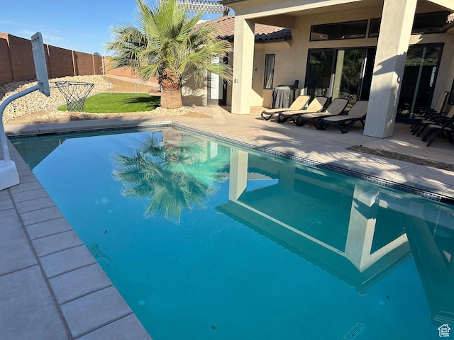 pool featuring a patio and fence