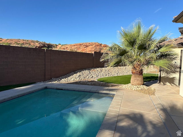 view of swimming pool featuring a patio, a fenced backyard, and a fenced in pool