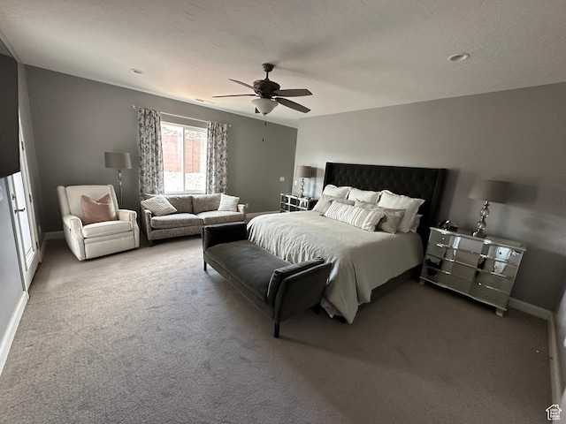 carpeted bedroom featuring a ceiling fan and baseboards