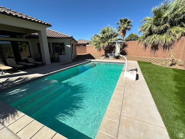 view of swimming pool with a fenced in pool, a patio, and a fenced backyard