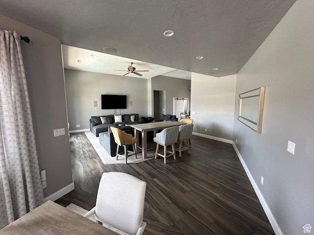 dining area with wood finished floors, baseboards, and ceiling fan