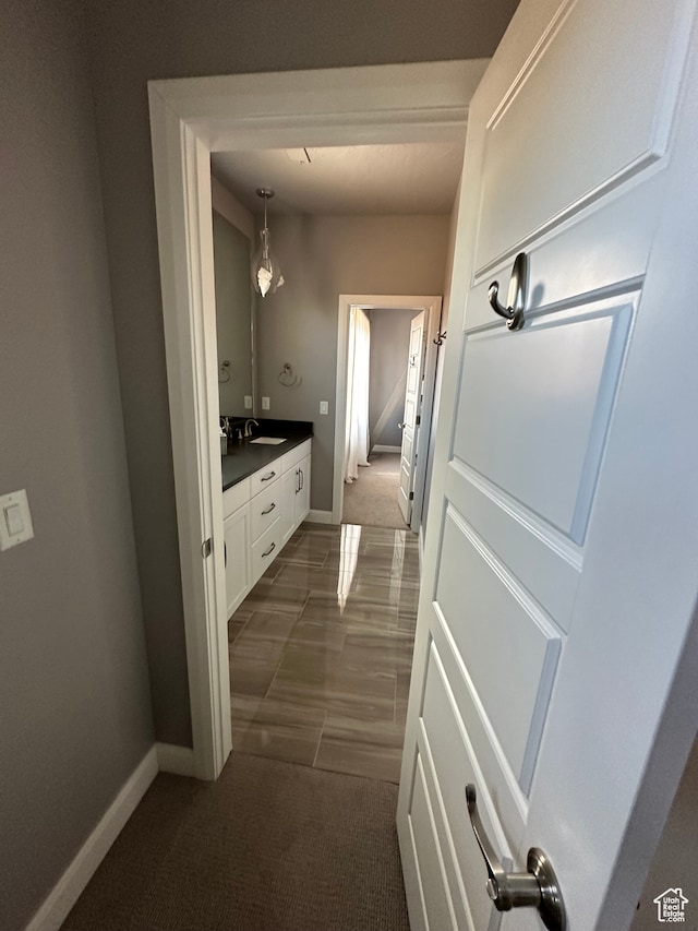 bathroom with vanity and baseboards
