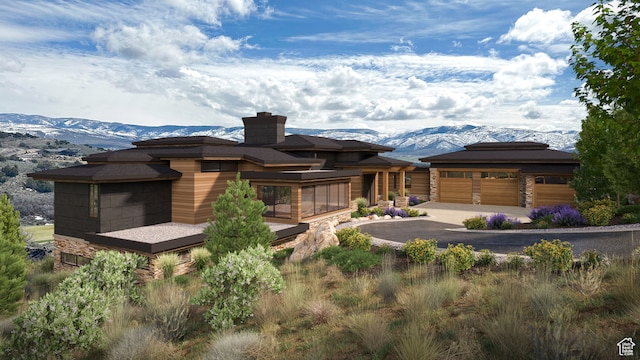 prairie-style home with a garage and a mountain view
