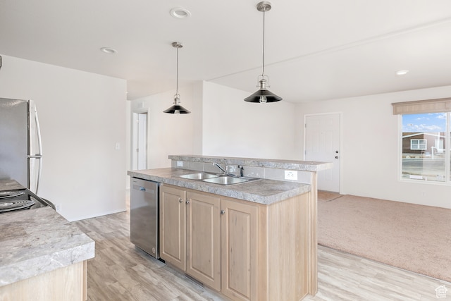 750 E 400 N Unit 220, Mount Pleasant, UT 84647 - kitchen with pendant lighting, appliances with stainless steel finishes, sink, light hardwood / wood-style floors, and an island with sink