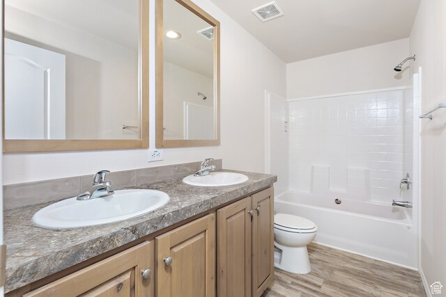 750 E 400 N Unit 220, Mount Pleasant, UT 84647 - full bathroom featuring vanity with extensive cabinet space, double sink, hardwood / wood-style floors, toilet, and  shower combination