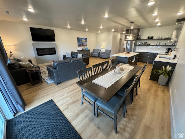 140 W 150 S Unit I32, Garden City, UT 84028 - dining space featuring recessed lighting, light wood-style flooring, visible vents, and a glass covered fireplace