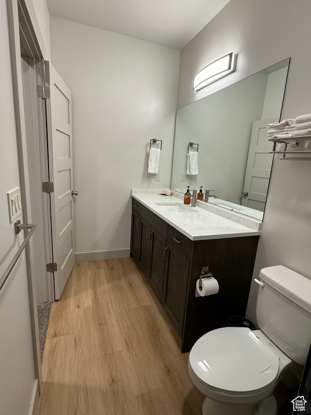 140 W 150 S Unit I32, Garden City, UT 84028 - bathroom with toilet, baseboards, wood finished floors, and vanity