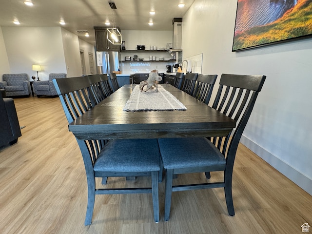 140 W 150 S Unit I32, Garden City, UT 84028 - dining space with light wood-style flooring and baseboards