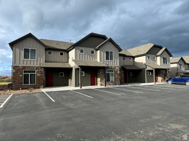 uncovered parking lot featuring a residential view