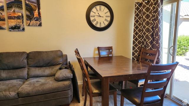 dining room with a wealth of natural light and wood-type flooring