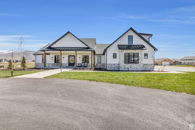 1429 S Hallam Rd Unit 2, Francis, UT 84036 - modern farmhouse style home with covered porch, a garage, and a front yard