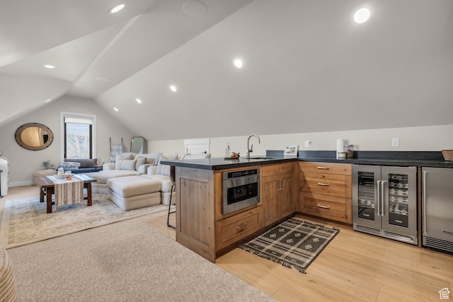 1429 S Hallam Rd Unit 2, Francis, UT 84036 - kitchen featuring a kitchen breakfast bar, oven, light wood-type flooring, beverage cooler, and sink