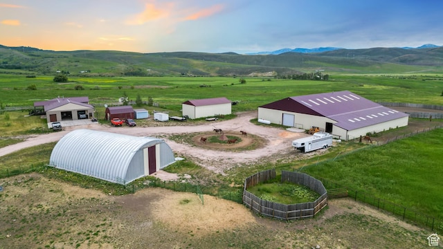aerial view at dusk with a rural view and a mountain view