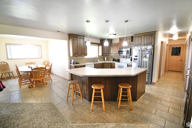 75 E 300 N, Glenwood, UT 84730 - kitchen with a wealth of natural light, appliances with stainless steel finishes, hanging light fixtures, and a center island