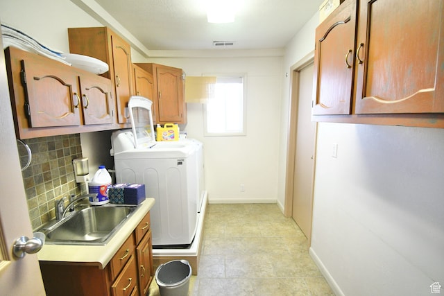 75 E 300 N, Glenwood, UT 84730 - clothes washing area featuring sink, cabinets, light tile floors, and washer and clothes dryer