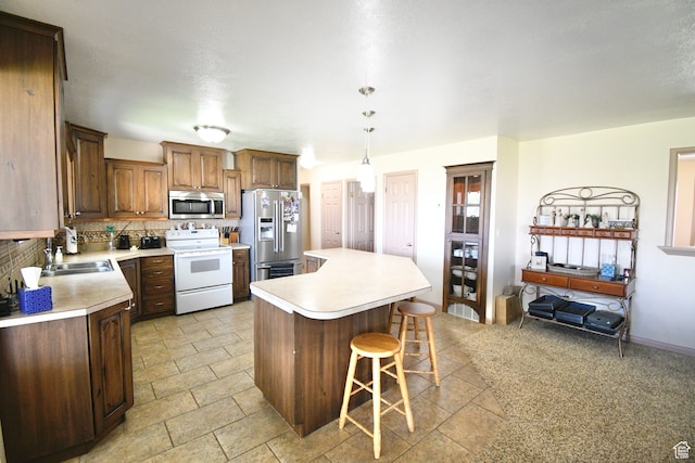 75 E 300 N, Glenwood, UT 84730 - kitchen featuring appliances with stainless steel finishes, light tile floors, sink, a kitchen island, and tasteful backsplash