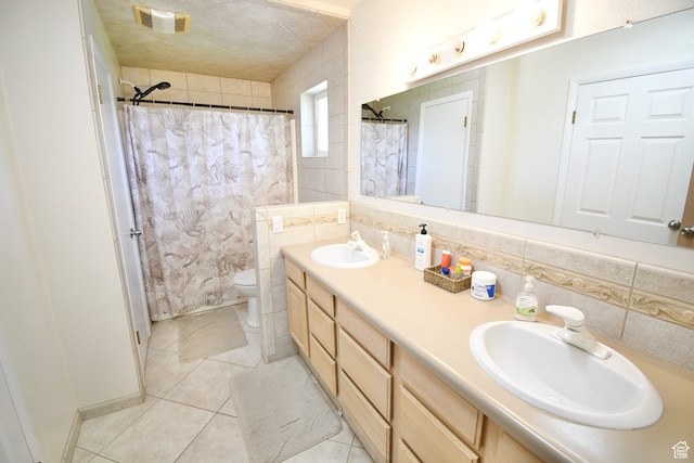 75 E 300 N, Glenwood, UT 84730 - bathroom featuring tile walls, backsplash, toilet, double vanity, and tile flooring