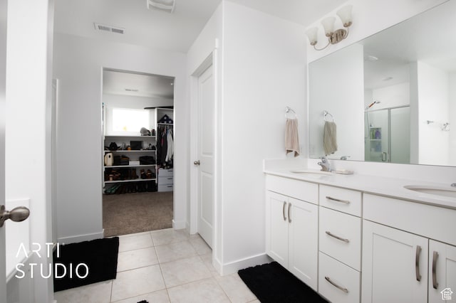 bathroom with dual bowl vanity and tile flooring
