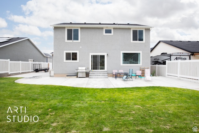 back of property featuring a yard and a patio