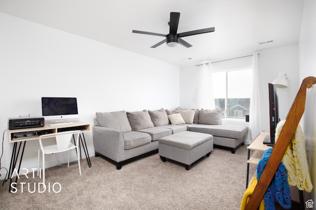 carpeted living room with ceiling fan