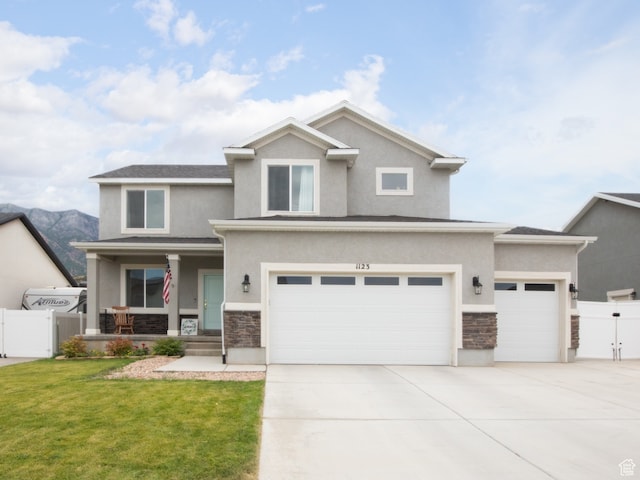 view of front of property featuring a garage and a front lawn