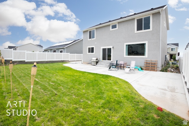 back of property featuring a patio and a lawn